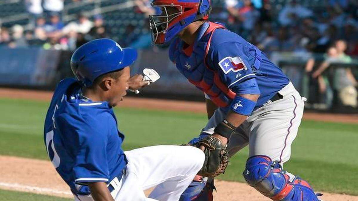
Kansas City Royals Terrance Gore scores the game winning run on a walk-off two run hit by Cheslor Cuthbert during Thursday's spring training game against the Texas Rangers on March 5, 2015 in Surprise, Ariz.
