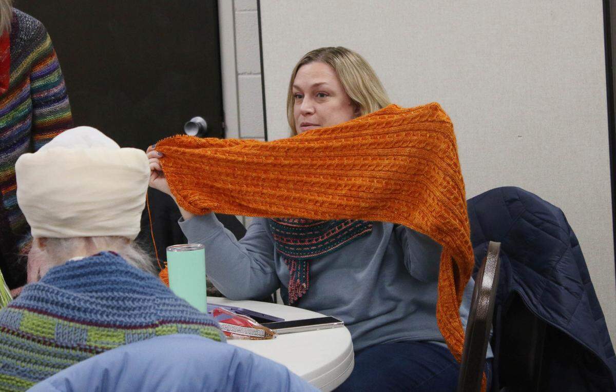 Overland Park resident Elisa Auckly shares her latest knitting work at a meeting of the Sunflower Knitters.
