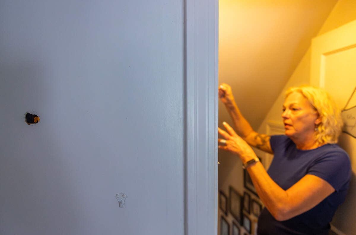 Marlene Standley shows where a bullet flew through her Waldo home earlier this month.