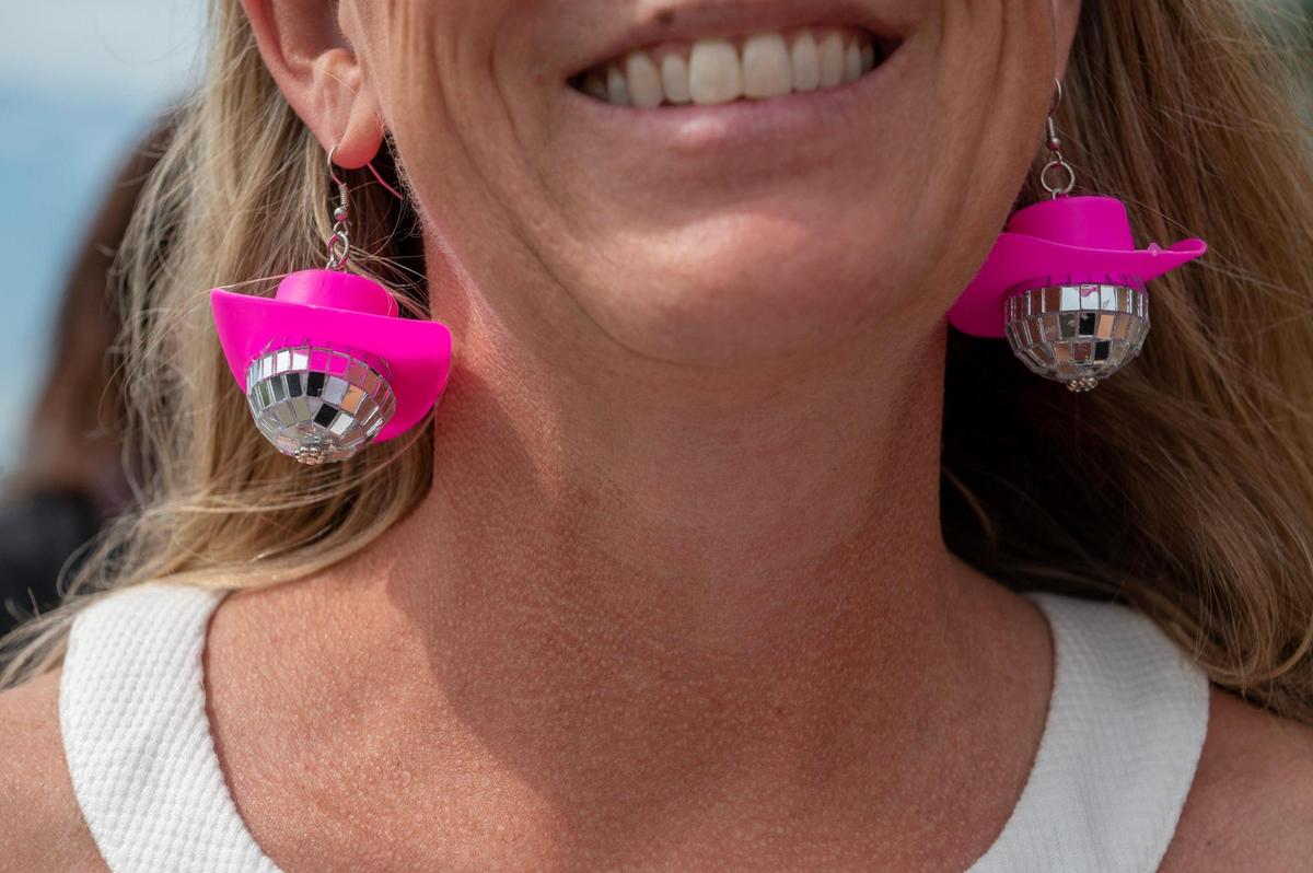 Stacey Etzmann, is seen wearing mirrorball cowboy hat earrings at Taylor Swift’s Eras Tour stop at GEHA Field at Arrowhead Stadium on Friday, July 7, 2023, in Kansas City.
