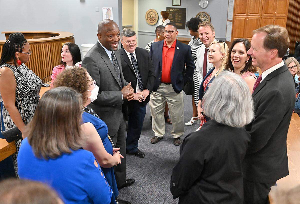 Mark Bedell chats with elected officials Friday prior to the school board approving a contract to make him the next superintendent for Anne Arundel County Public Schools in Maryland. Bedell is the former superintendent for Kansas City Public Schools.