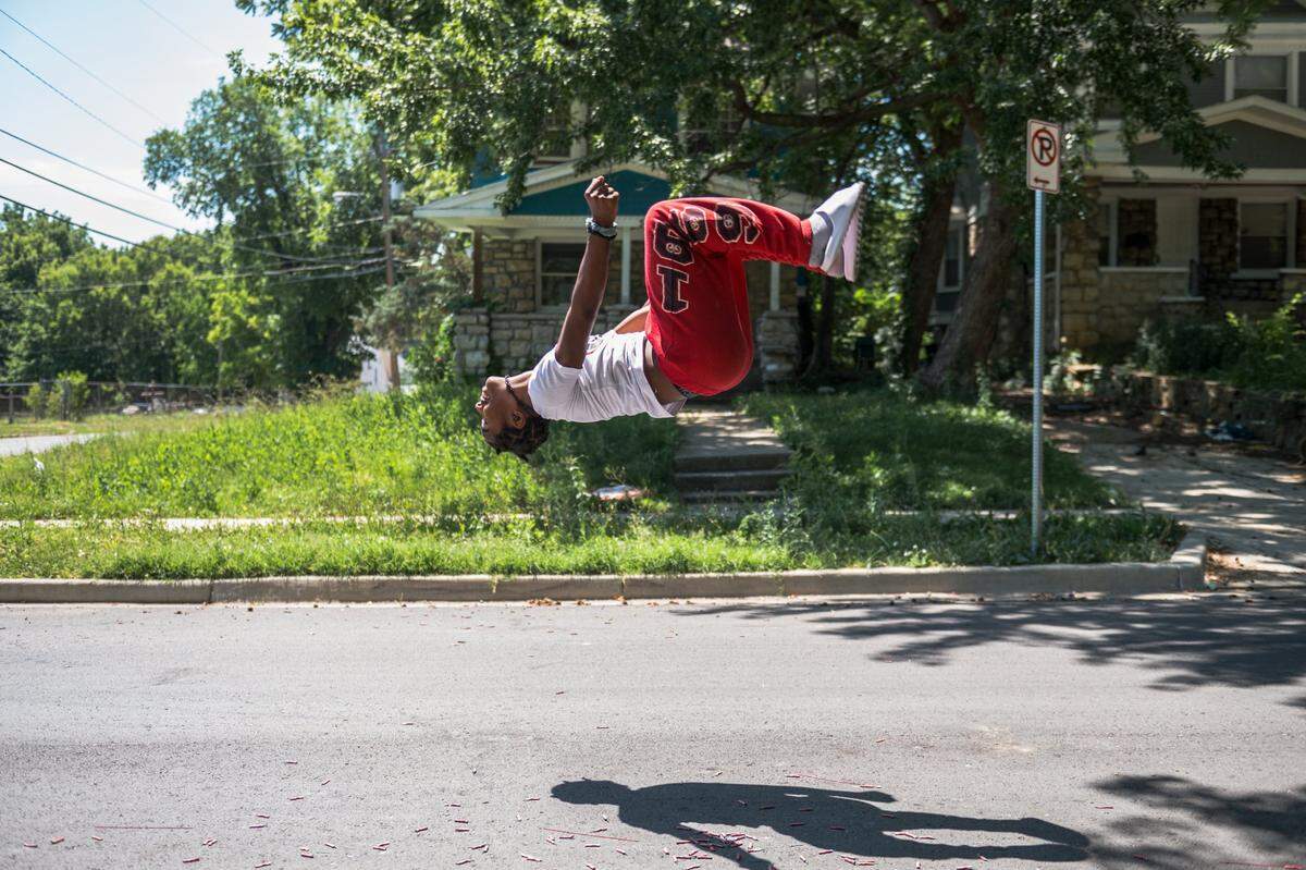 Keon Moore backflips in the street of the Oak Park Northwest neighborhood on Tuesday, July 4, 2023, in Kansas City. All throughout the neighborhood residents held block parties, barbecues, and shot off fireworks.