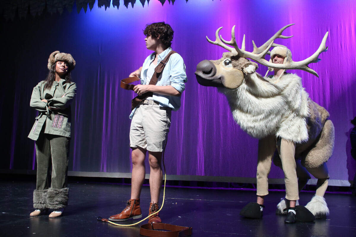 Sydney Carter banters with Devin Cunagin as Luke Peterson looks on during a rehearsal for the Olathe School District’s production of “Frozen.”