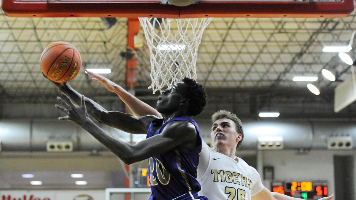 North Kansas City forward Riak Mabour goes up for a layup against Lee’s Summit forward Max Whisner during Thursday evening’s game, Dec. 27, 2018, at William Jewell College in Liberty. The score was tied 27-27 at the end of the first half and tied 40-40 at the end of the third quarter but North Kansas City pulled out a 58-47 victory in this game of the 39th Annual William Jewell High School Holiday Classic, which concludes Dec. 29.