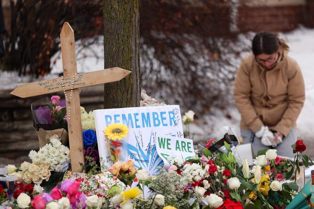 People gather at a makeshift memorial for 37-year-old Renee Nicole Good, who was shot and killed at point blank range on Jan. 7 by a US Immigration and Customs Enforcement (ICE) agent as she apparently tried to drive away from agents who were crowding around her car, in Minneapolis, Minnesota, on Jan. 8, 2026. Good lived in Kansas City as recently as 2023, according to court records.