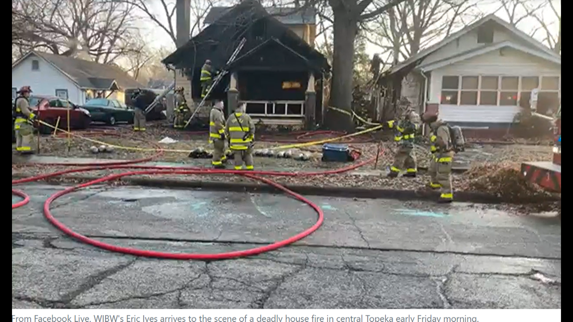 Firefighters at the scene of the house fire after it was extinguished.