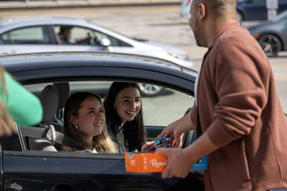 Visitors receive candy as they pull up to Russell Stover's headquarters during the company's annual Halloween giveaway on Friday, Oct. 31, 2025, in Kansas City.