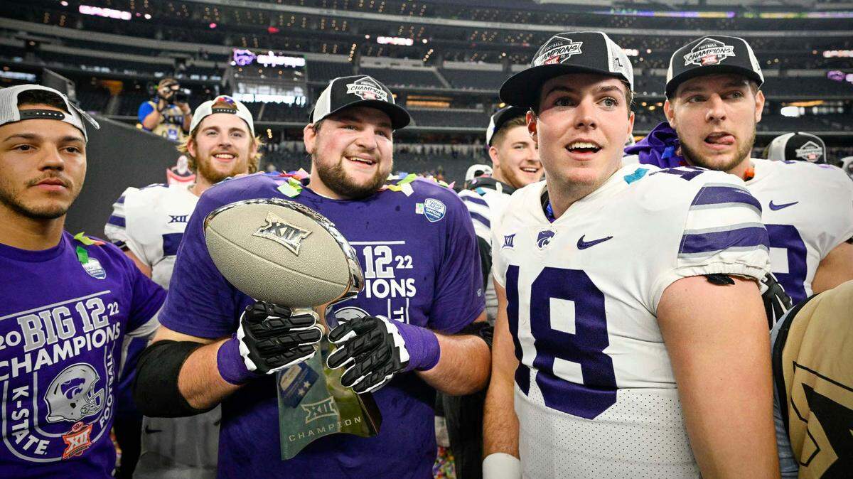 Kansas State Wildcats quarterback Will Howard (18) and his teammates celebrate winning the Big 12 championship after defeating the TCU Horned Frogs in overtime at AT&T Stadium on Dec. 3, 2022.