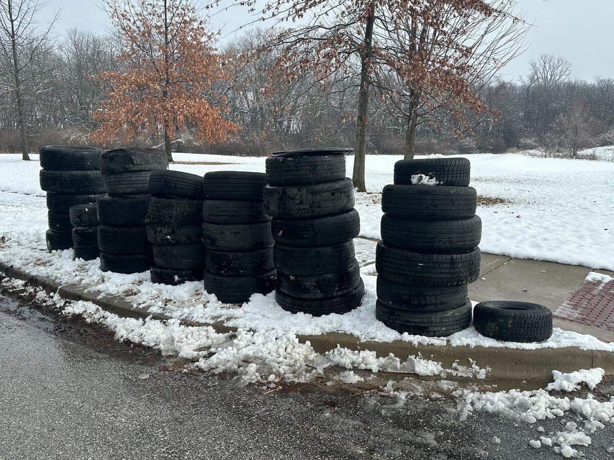 Eduard Beijen hauled littered tires to the curb so the city could get rid of them.