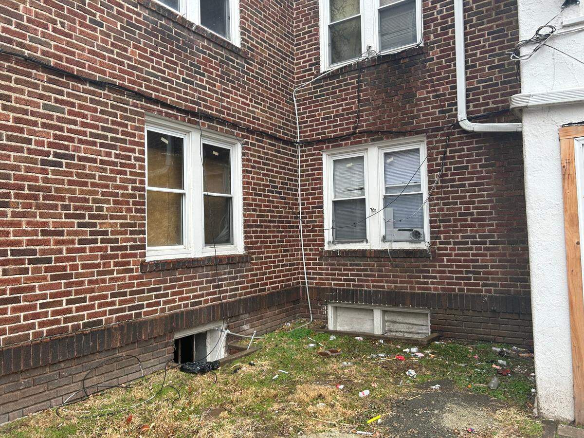 The property on Lawn Avenue has boarded-up windows from repeated break-ins.