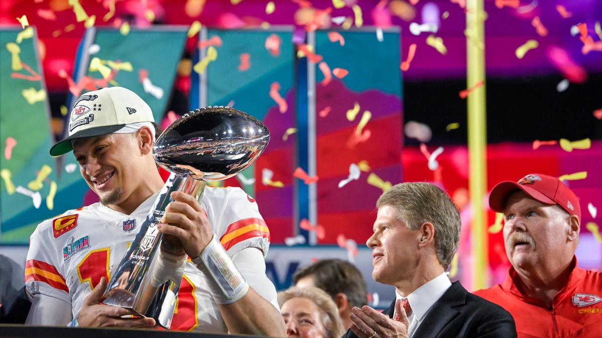 Kansas City Chiefs quarterback Patrick Mahomes (15) hoists the Lombardi Trophy after leading the Chiefs to a Super Bowl LVII victory, 38-35, over the Philadelphia Eagles on Sunday, Feb. 12, 2023, at State Farm Stadium in Glendale, Arizona. Chiefs Chairman & CEO Clark Hunt and Head Coach Andy Reid look on.