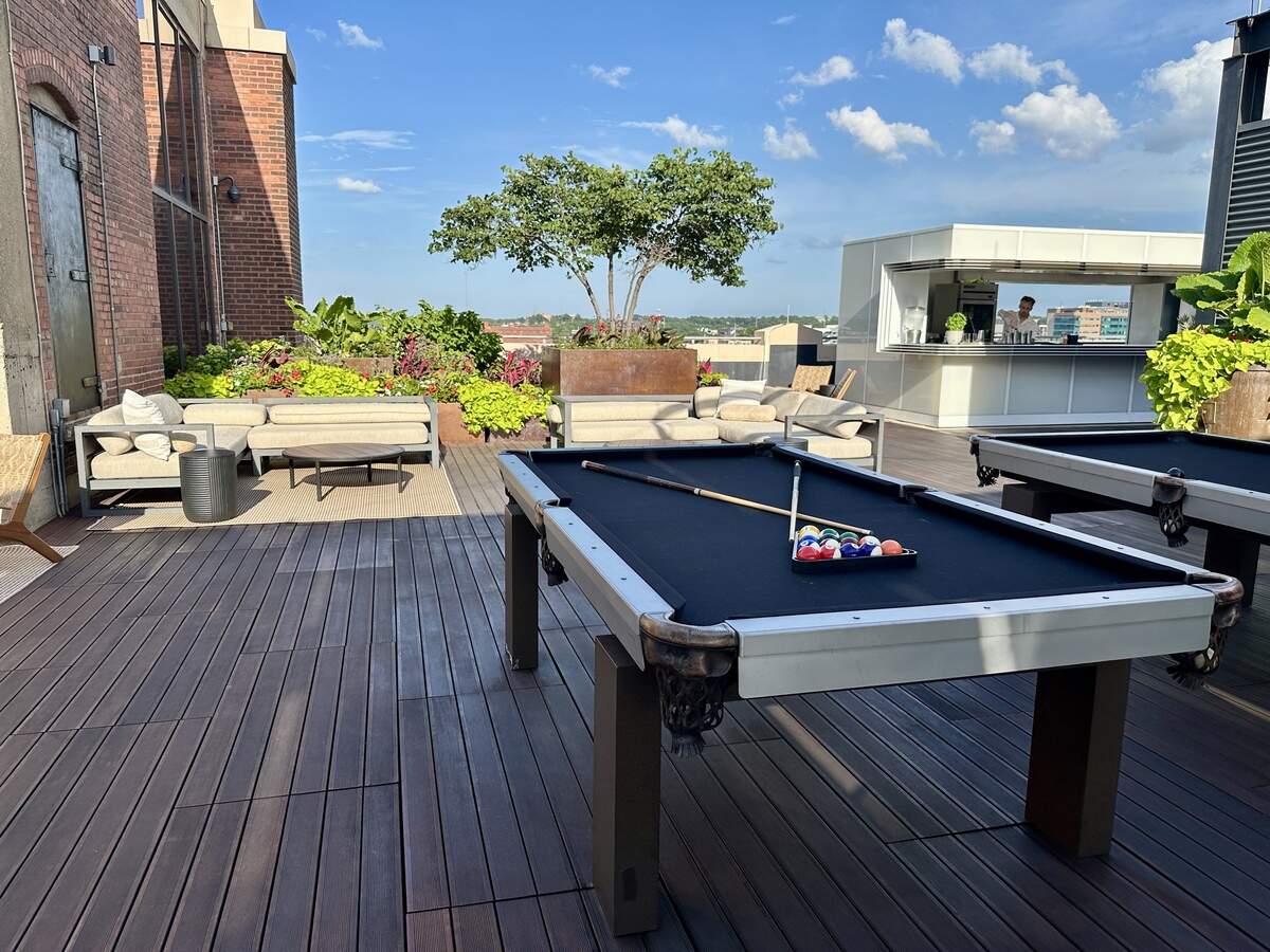 RooftopKC, Kansas City’s newest rooftop bar, offers cocktails, wine and beer to drink, and guests can play pool at two available tables.