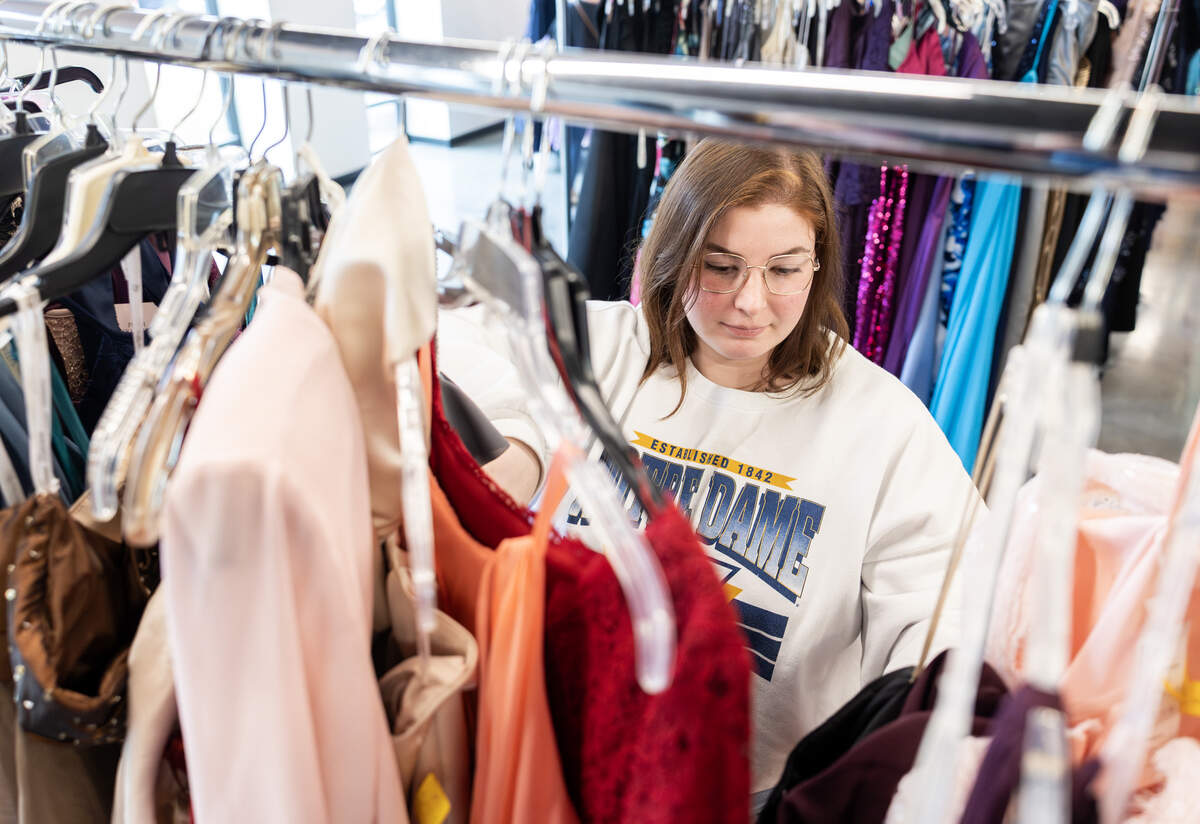 Lexi Cooper sorts through dresses on a rack at Woods Chapel United Methodist Church’s Prom Boutique on Wednesday, March 4.