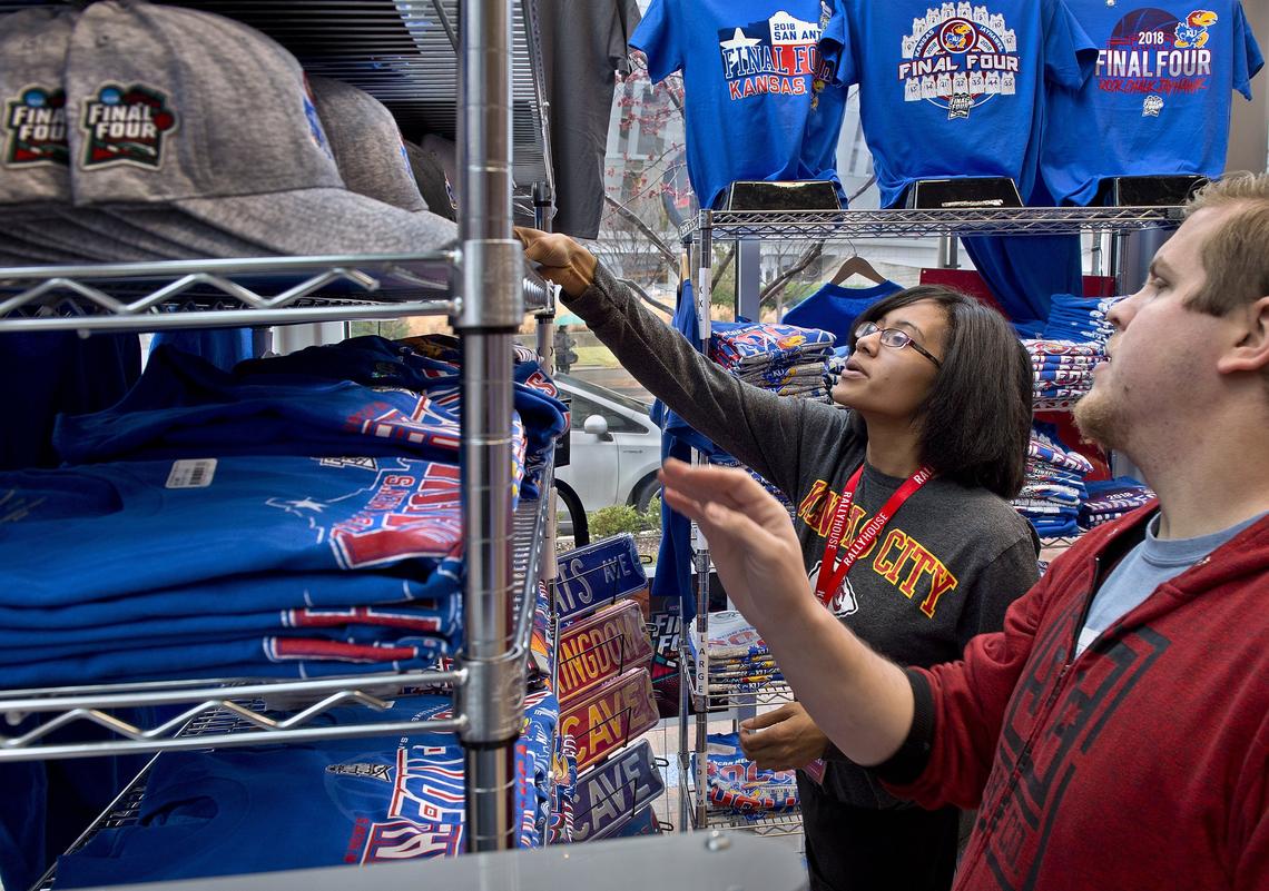 Manager-in-training Gabbii Smith helped Brett Overly of Kansas City find a KU Final Four item for a friend this week at the Rally House in the Power & Light District.