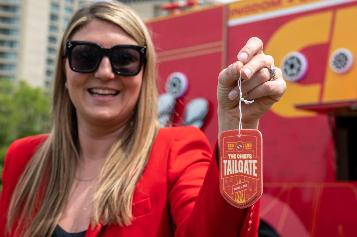 Lara Kurg, Kansas City Chiefs marketing officer, holds a car freshener during the Chiefs Kingdom Experience preview on Wednesday, April 26, 2023, in Kansas City. Kurg said that the car freshener was inspired by game day at Arrowhead Stadium. Fans will have the opportunity to snag a freshener for free.