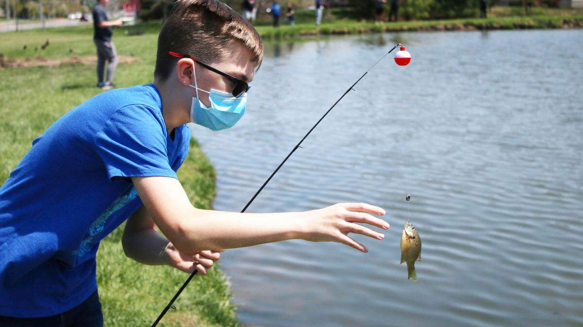 Gabe Hugo, 11, gets a closer look at the fish he caught during gym class at Chisholm Trail Middle School.