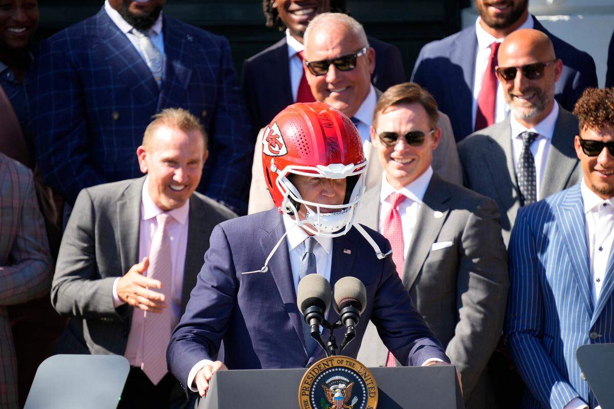 President Joe Biden wears an autographed helmet during the Kansas City Chiefs visit to the White House to celebrate their championship season and victory in Super Bowl LVIII on Friday, May 31, 2024.