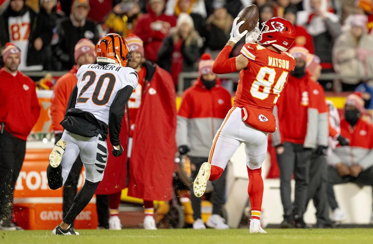 Kansas City Chiefs wide receiver Justin Watson (84) catches a pass as Cincinnati Bengals cornerback DJ Turner II (20) gives chase during an NFL football game at GEHA Field at Arrowhead Stadium on Sunday, Dec. 31, 2023, in Kansas City.