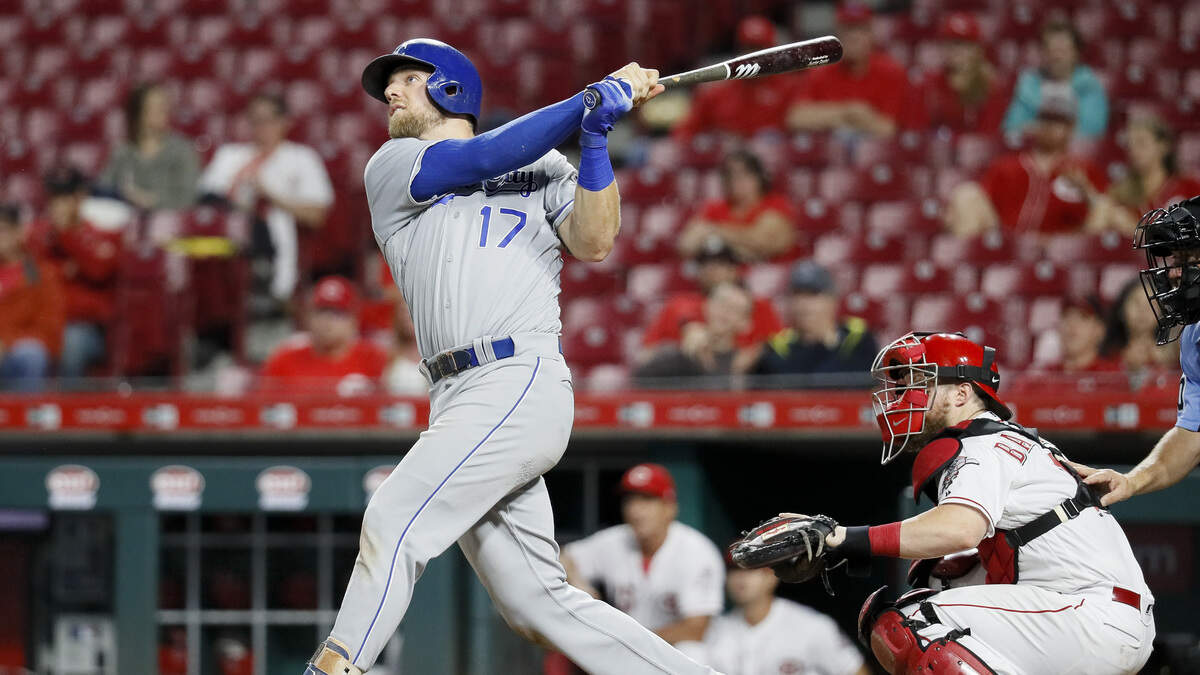 Kansas City Royals’ Hunter Dozier follows through on a go-ahead home run off Cincinnati Reds relief pitcher Raisel Iglesias during the ninth inning Tuesday in Cincinnati.