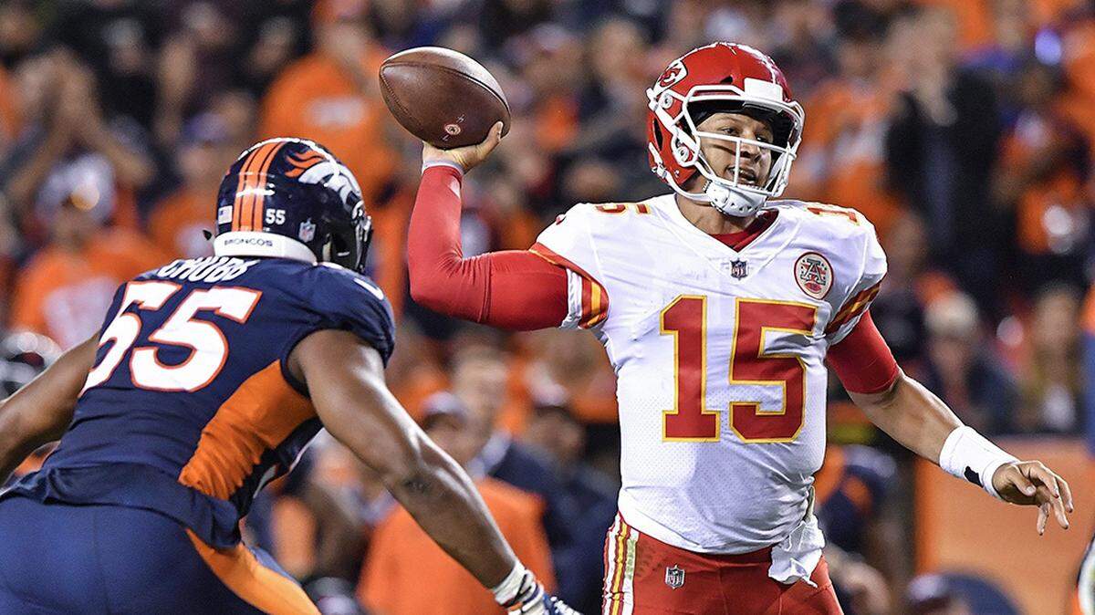 Kansas City Chiefs quarterback Patrick Mahomes scrambles away from Denver Broncos defensive back Darian Stewart and linebacker Bradley Chubb in the third quarter during Monday’s football game on October 1, 2018 at Mile High Stadium in Denver, Colorado