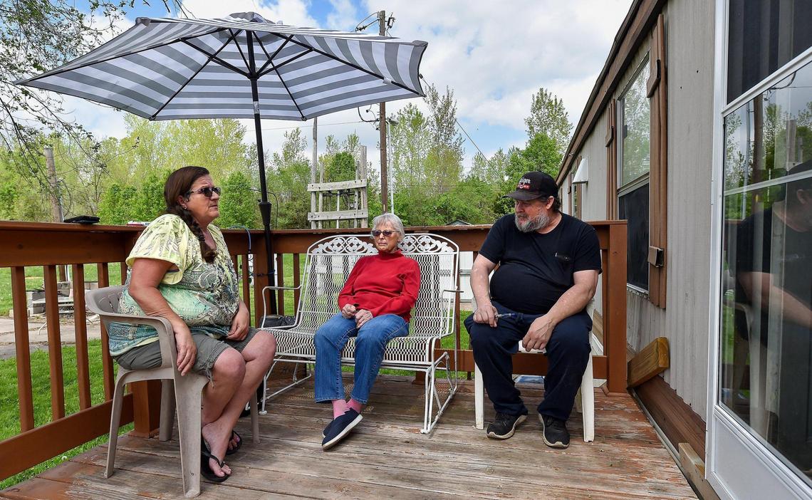 Jeannie Anderson, left, said she doesn’t know where she’d go if she were forced to move out of her home in the Heart Mobile Village trailer park. Neighbors Joy Ufford and her son Gregg Ufford chatted on Anderson’s porch recently. The Uffords also have no idea what they will do if forced to move.
