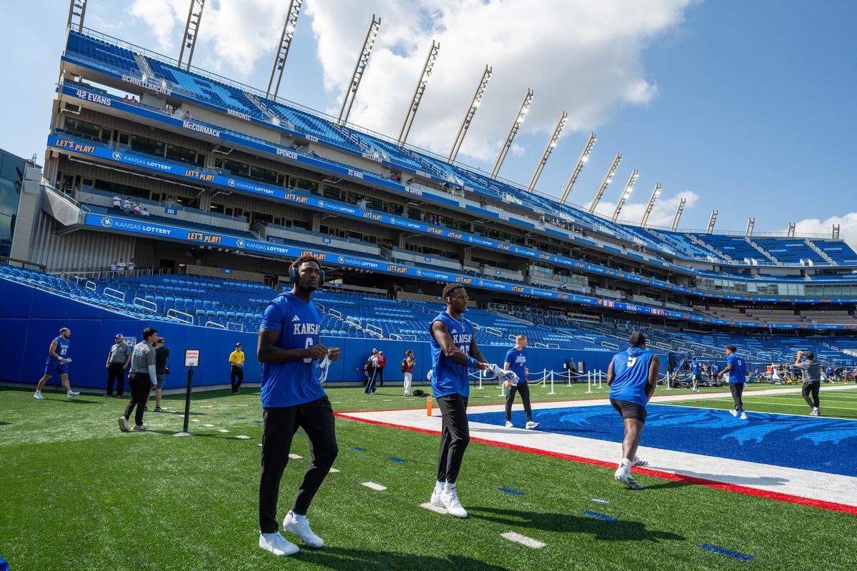 Kansas Jayhawks football players walk the field and check out the new David Booth Kansas Memorial Stadium on Saturday, Aug. 23, 2025, in Lawrence.