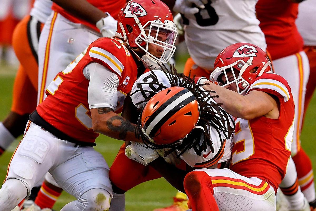 The Chiefs’ Tyrann Mathieu, left, and Dan Sorensen take down Cleveland’s Kareem Hunt during the second half of Sunday’s game at Arrowhead.