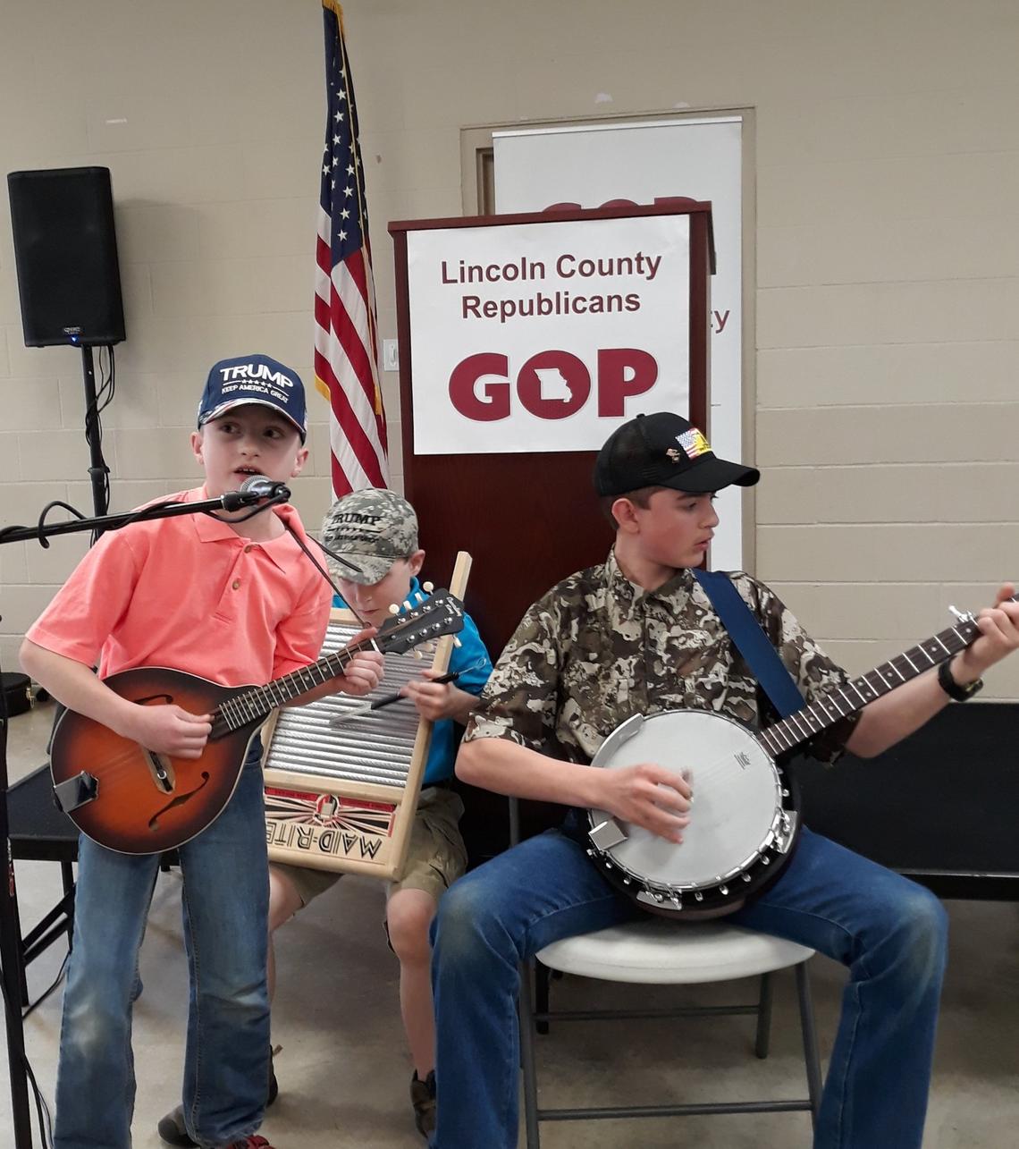 Brothers Ezekiel, from left, Ezra and Boaz Grimstead provided entertainment during the Lincoln County Republican Club’s second annual potluck dinner at the Troy Holiness Church Fellowship Hall in Troy, Missouri.