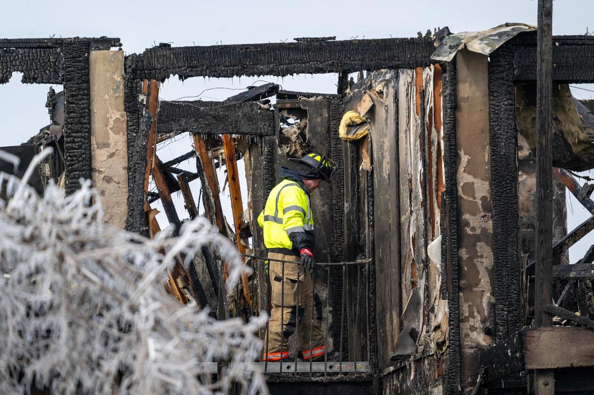 Fire investigators looked over the top floor of an apartment building that was destroyed by a massive fire at the Indy Ridge Apartment complex near Missouri 291 highway and East 39th Street in Independence on Wednesday, Jan. 22, 2025.
