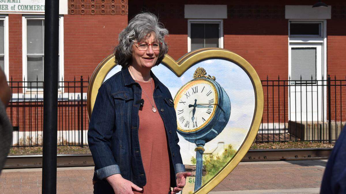 Beth Martens stands with her Parade of Hearts heart in downtown Lee’s Summit.