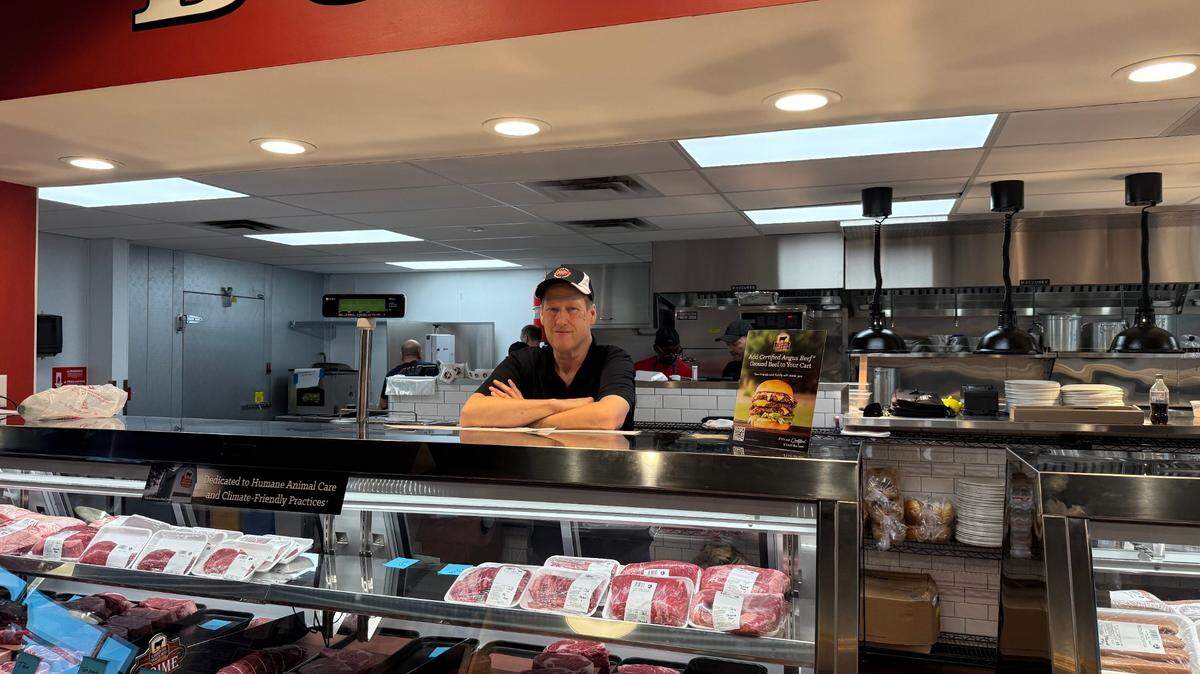 Scott Sovereign, a franchise owner of New York Butcher Shoppe, stands behind a case of meat at a new Kansas City butcher shop.