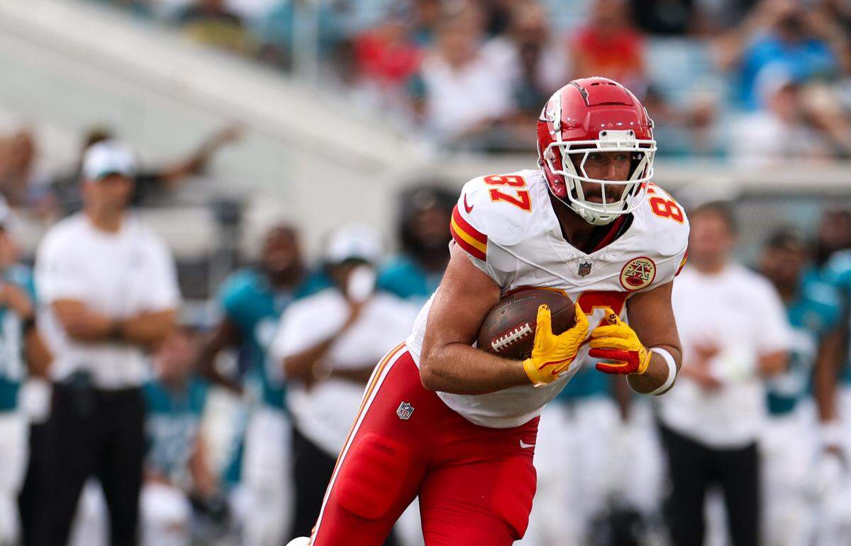 Kansas City Chiefs tight end Travis Kelce (87) runs with the ball against the Jacksonville Jaguars in the first quarter during preseason at EverBank Stadium.