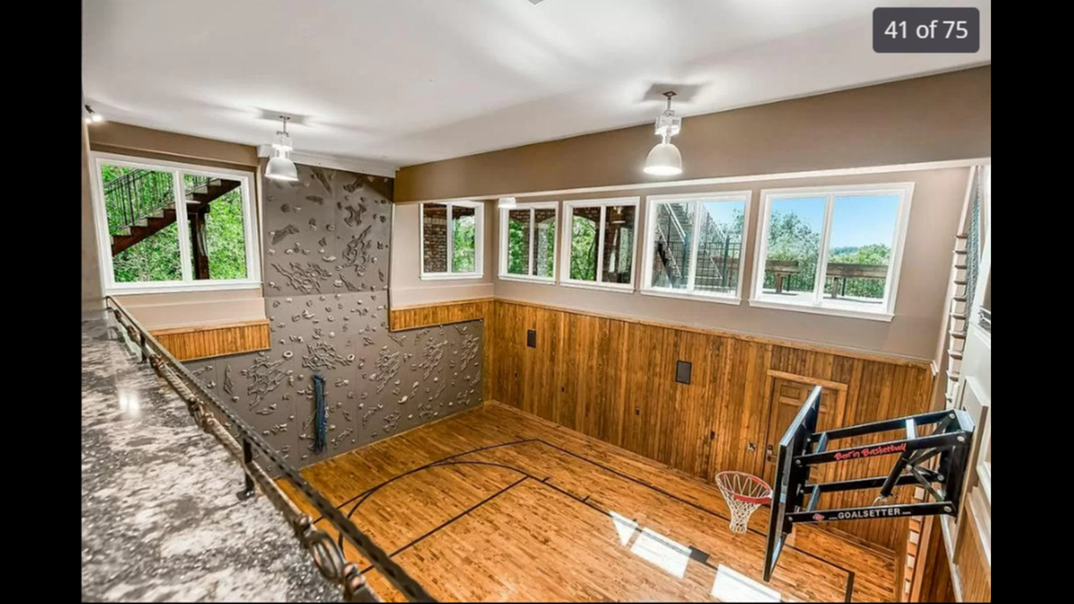 The basement level in the house at 27596 W. Highland Circle in Olathe features an indoor basketball court and a rock climbing wall.