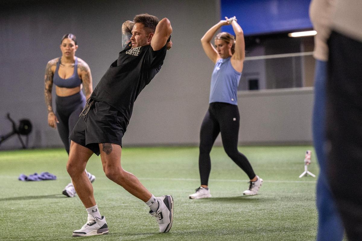 Stroupe leads participants through a mobility exercise during a training session at Homefield Kansas City in Olathe.