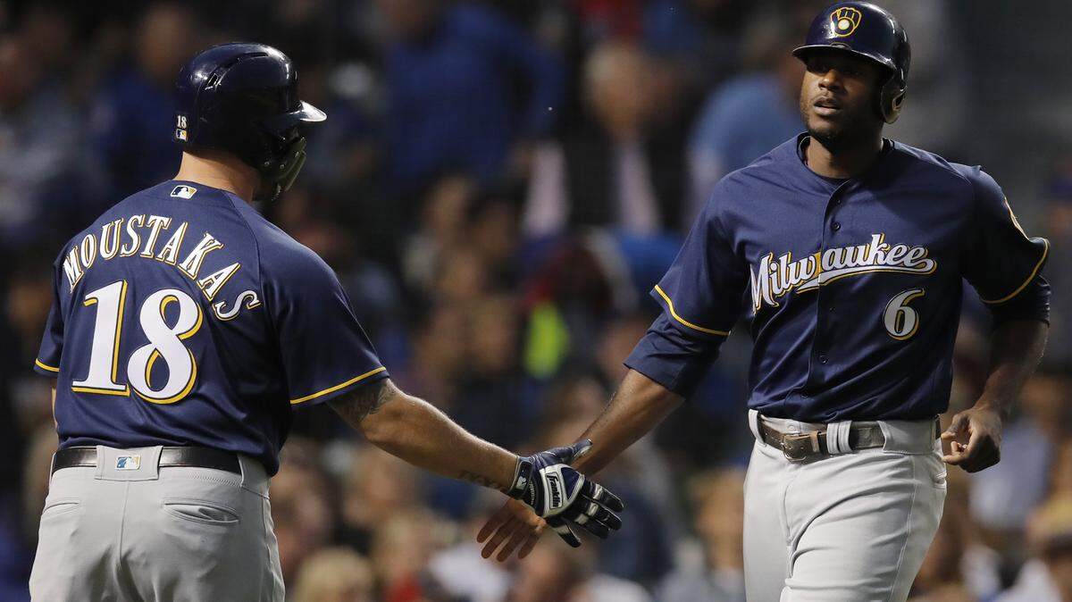 Milwaukee Brewers’ Lorenzo Cain, right, celebrated scoring a run against the Chicago Cubs with teammate Mike Moustakas during the first inning of a baseball game Monday, Sept. 10, 2018, in Chicago.