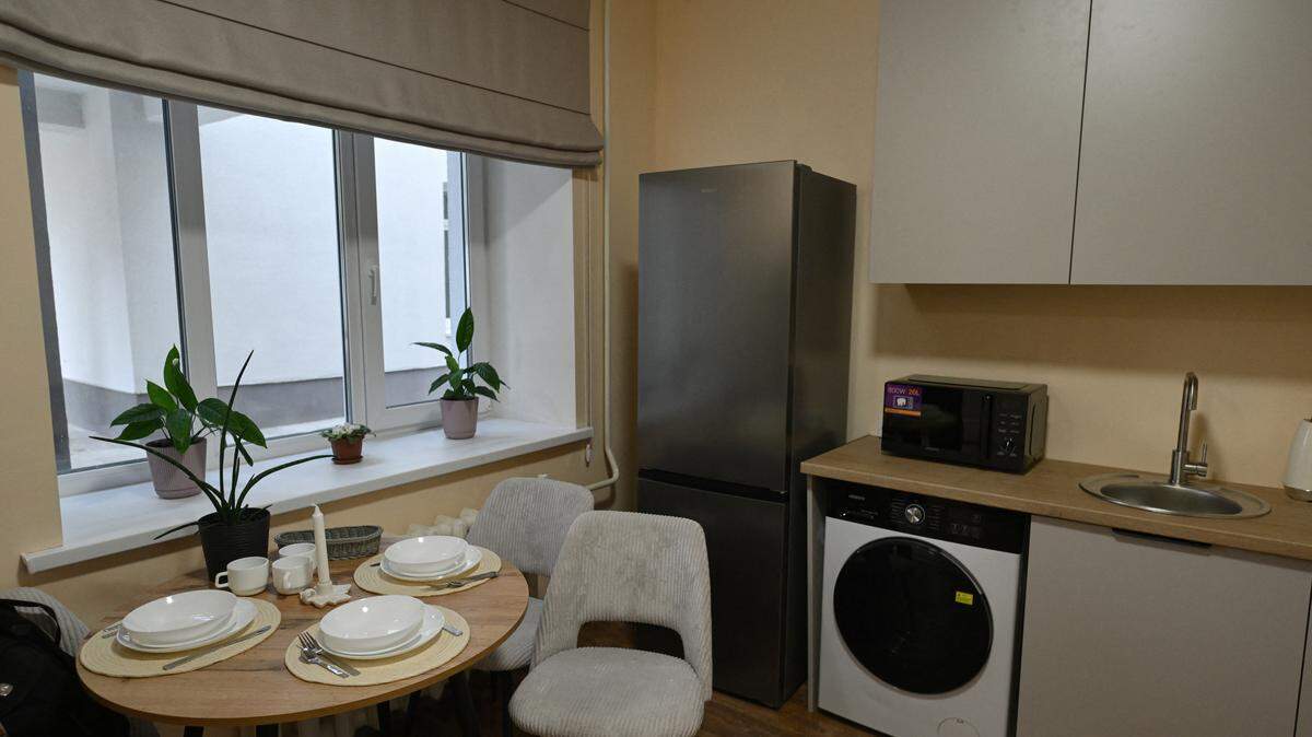 A kitchen with a dining room table.