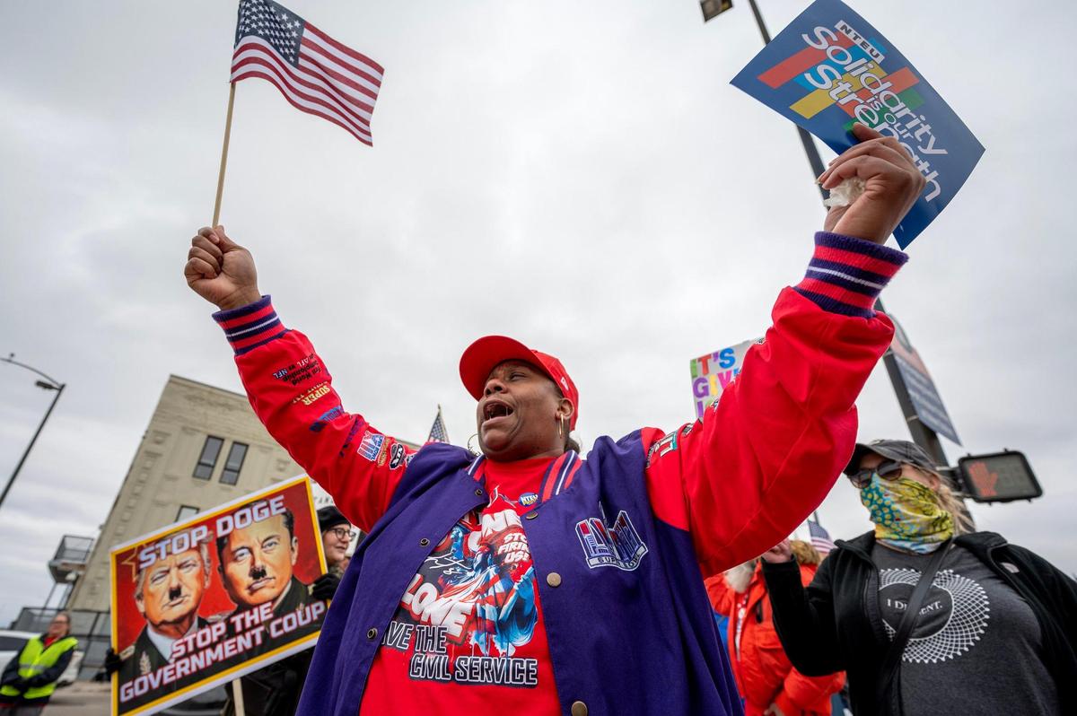Rajia Pennington rallies in support of federal workers along West Pershing Road on Saturday, March 15, 2025, in Kansas City.