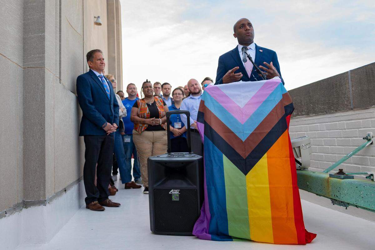 Kansas City Mayor Quinton Lucas shares remarks about the city’s human rights initiatives as city workers gather to watch the Pride flag be raised on the City Hall flagpole in Kansas City on June 2, 2022.