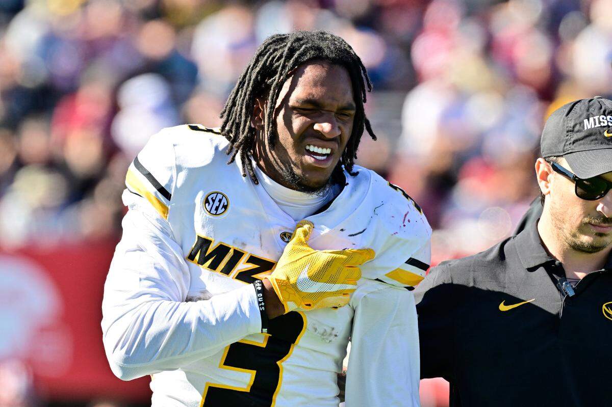 Missouri Tigers wide receiver Luther Burden III is helped off the field after being injured on a play in the third quarter of Saturday’s game against the Massachusetts Minutemen at Warren McGuirk Alumni Stadium in Amherst, Mass.