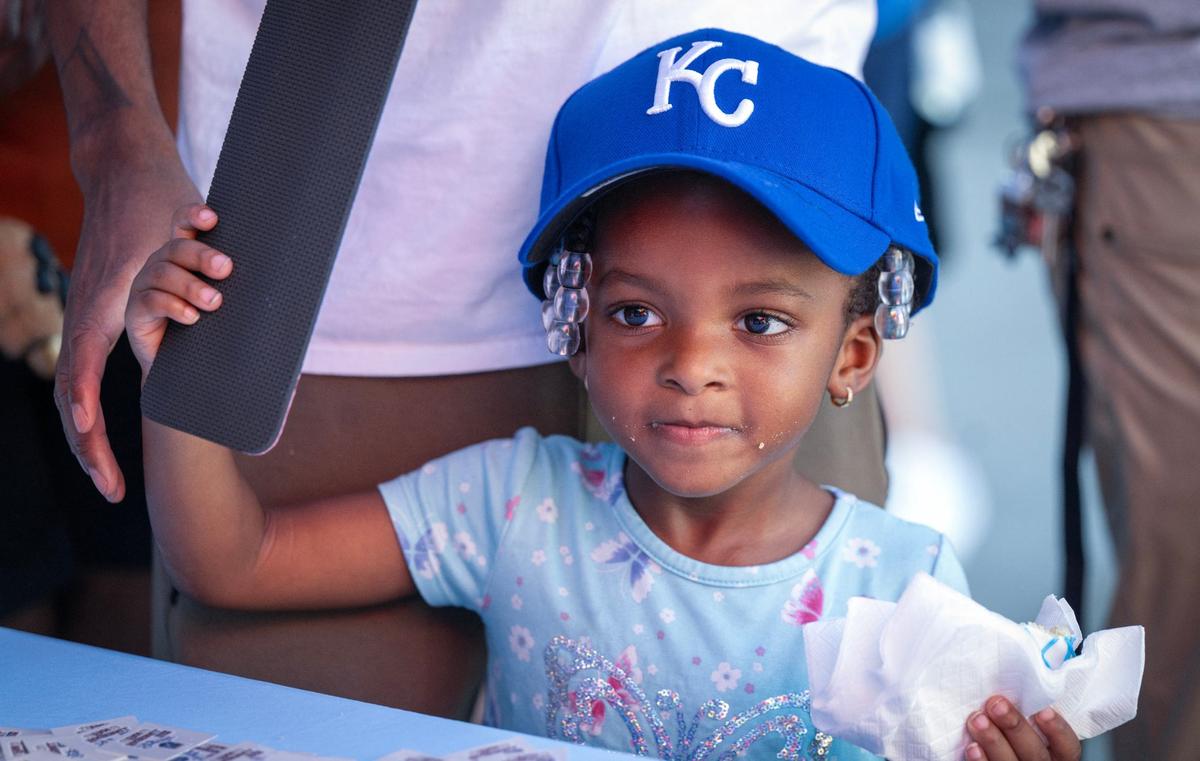Three-year-old Royals fan Alei Bland showed off her new Royals cap, a gift received at Bring Out the Blue, a tailgating event at the Price Chopper in Lee’s Summit on Monday, Sept. 30, 2024.