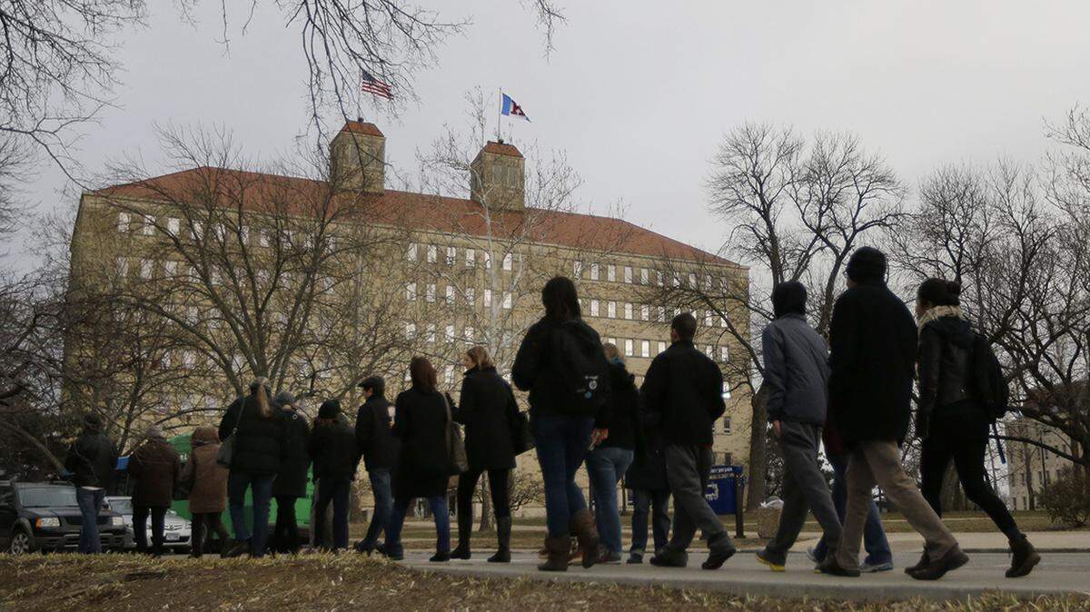 University of Kansas students and faculty walk past Fraser Hall on campus. The Kansas Board of Regents recently asked universities to list courses that include Critical Race Theory.