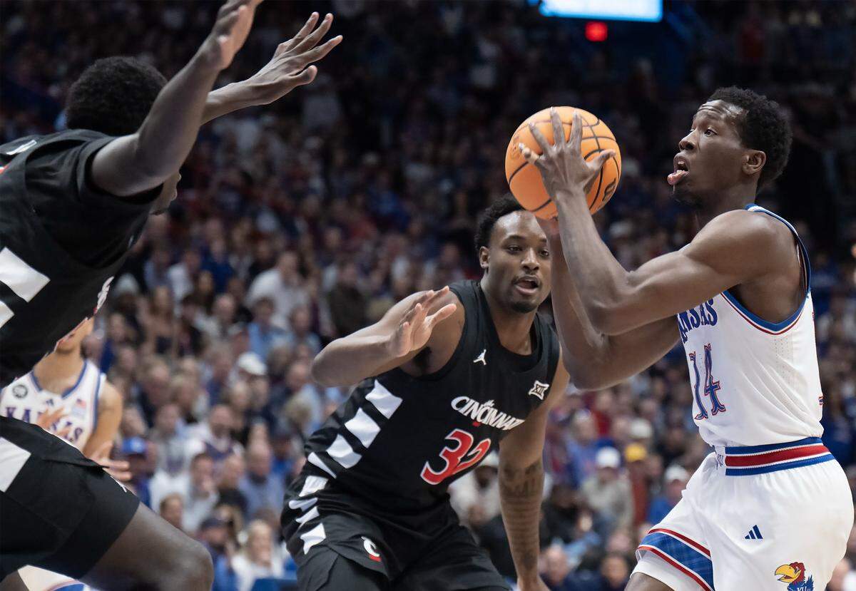 Kansas Jayhawks guard Melvin Council Jr. (14) goes to shoot as Cincinnati Bearcats forward Jalen Celestine (32) defends in the first half Allen Fieldhouse on Saturday, Feb. 21, 2026, in Lawrence, Kansas.