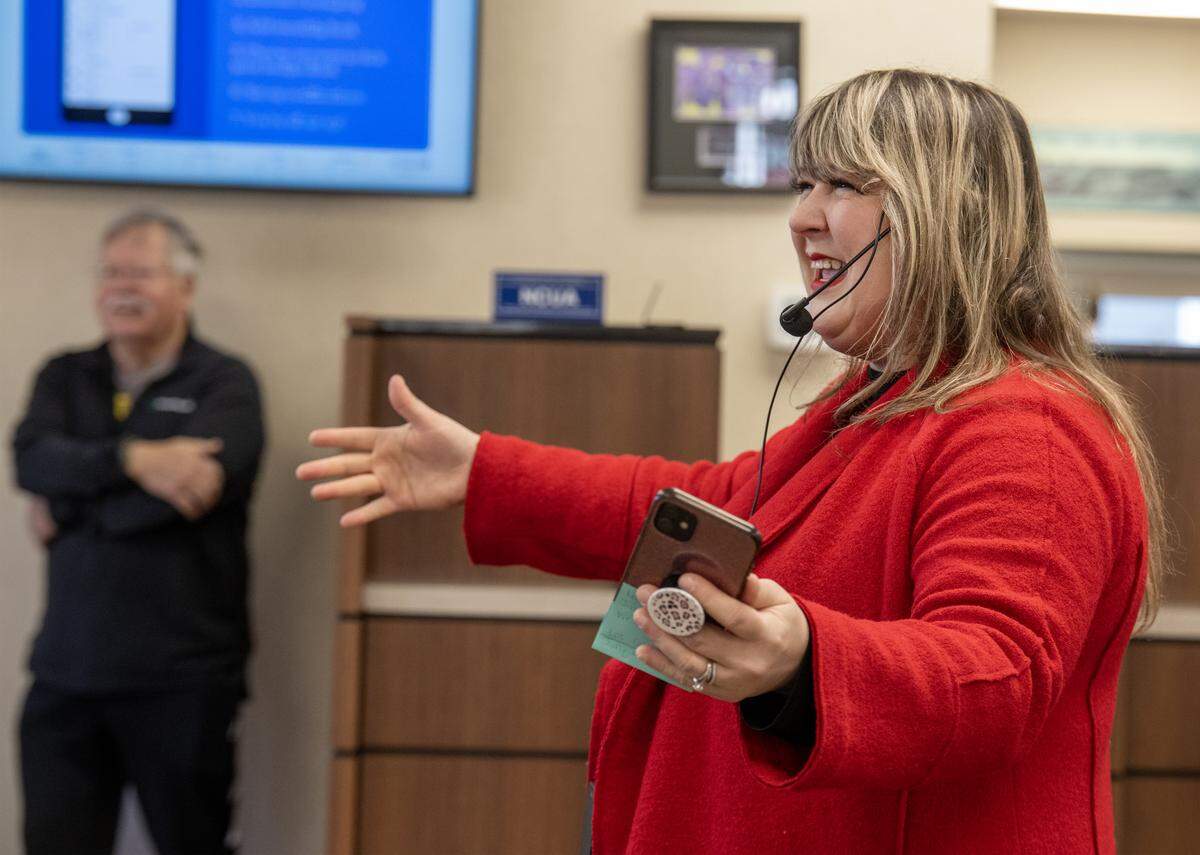 Music teacher Rachel Marlow of Central Elementary School in Olathe directs students in the special chorus as they sing Christmas carols during a visit to the Main Street Credit Union in downtown Olathe on Wednesday, Dec. 17, 2025. 