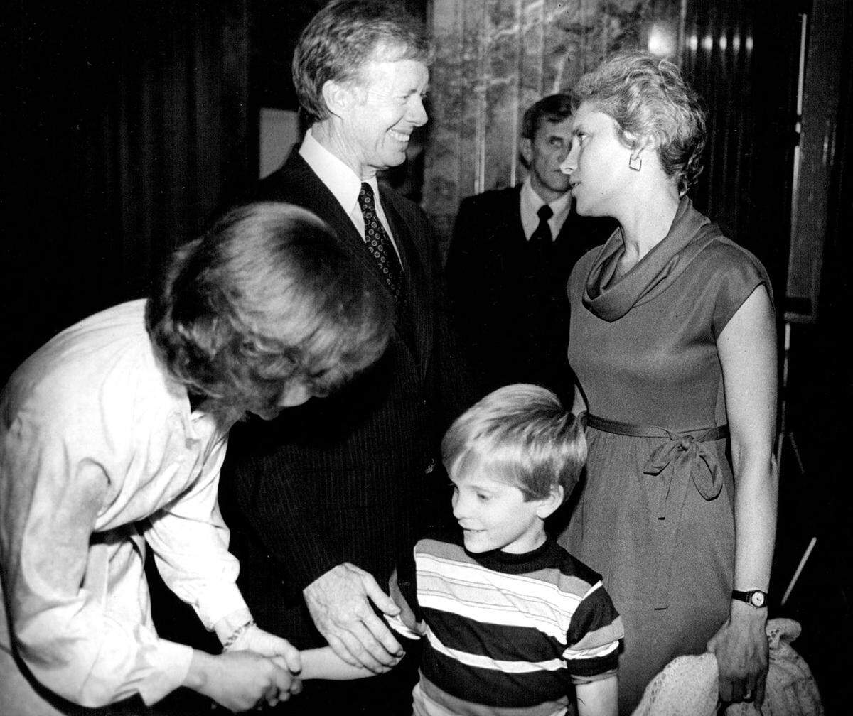 President Jimmy and Rosalynn Carter greeted Mrs. Douglas Young and her son, Douglas Young III, at a reception at the Jackson County Courthouse. They are the family of Douglas Young, a county legislator.