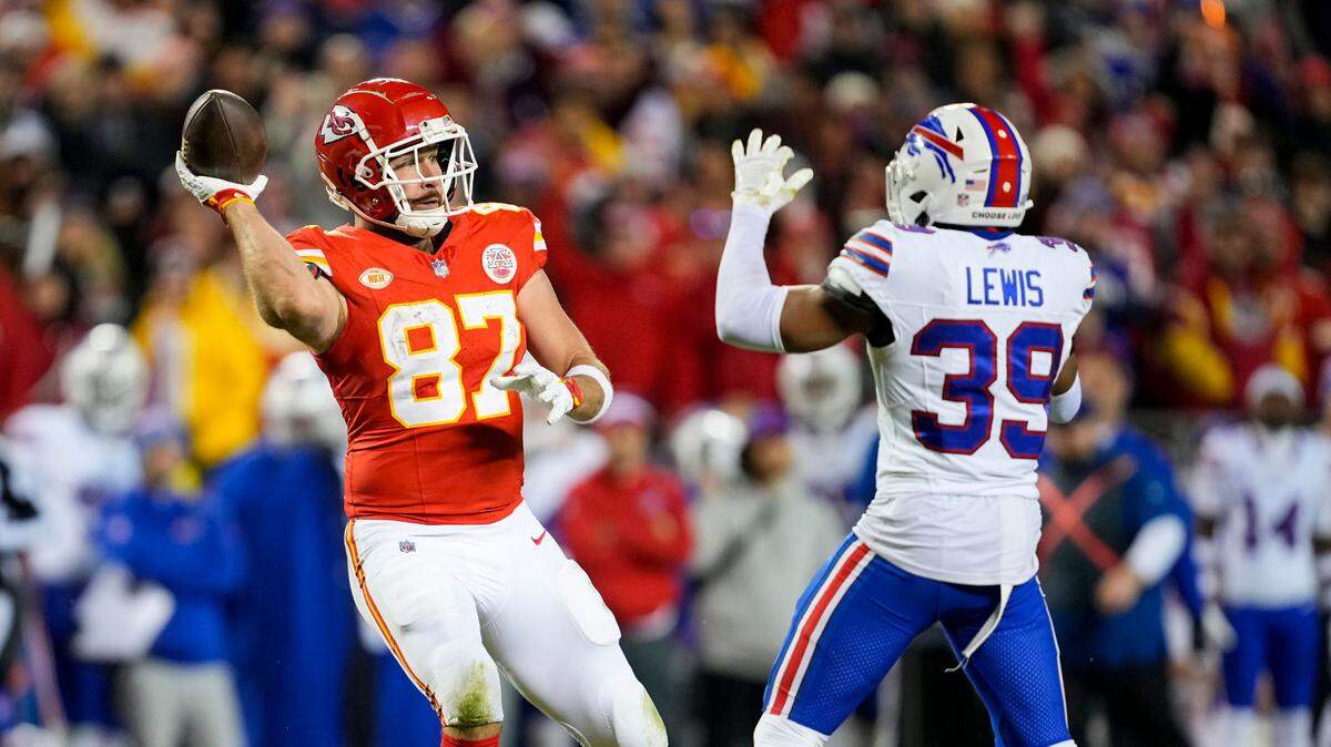Kansas City Chiefs tight end Travis Kelce (87) laterals the ball in front of Buffalo Bills cornerback Cam Lewis (39) during the second half at GEHA Field at Arrowhead Stadium on Dec. 10, 2023.