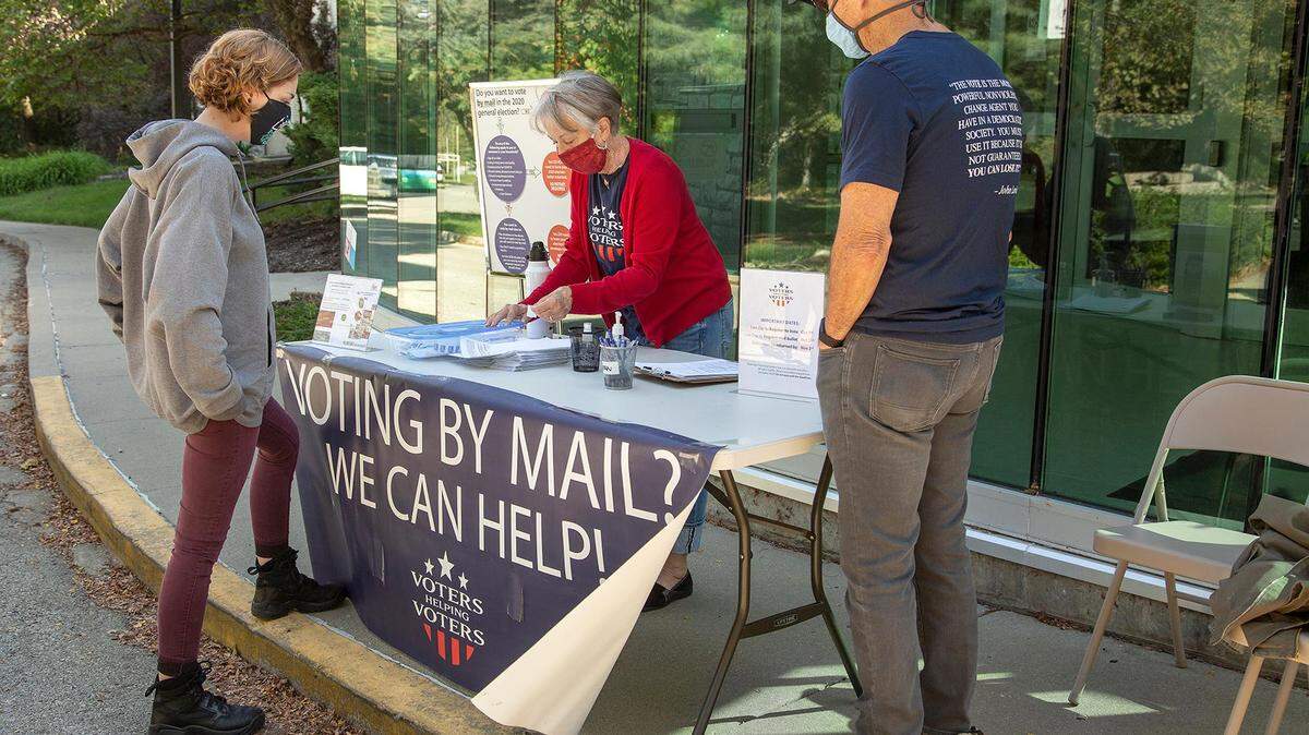 Volunteers with Voters Helping Voters give out information about how to register to vote at the Westport Roanoke Community Center on Saturday, October 3, 2020.