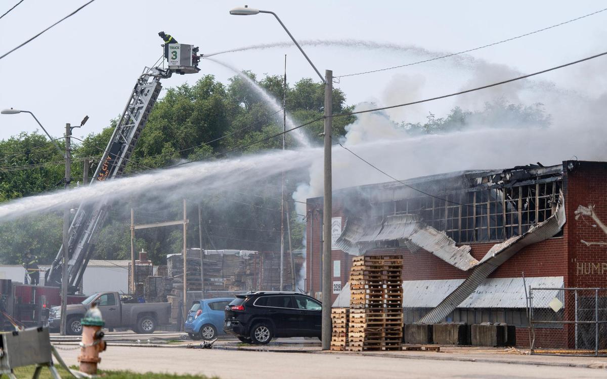 Firefighters battle a blaze at Pioneer Pallet in the 3500 block of Nicholson Ave. on Thursday, June 15, 2023, in Kansas City.