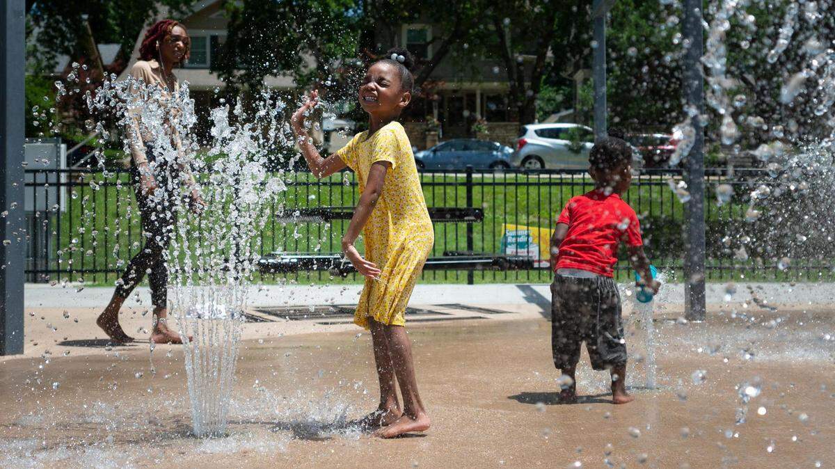 Tamara Nelson, 5, plays in the water features at Gillham Park on June 14, 2022, as a heatwave engulfs Kansas City.