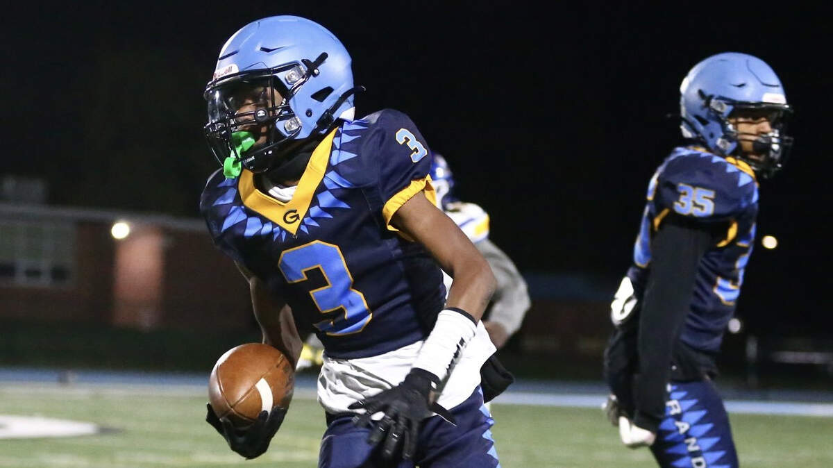 Grandview High’s Ja’Lyne Armstrong, left, returns a punt 45 yards during the Bulldogs’ 56-0 win over Center on Friday night.