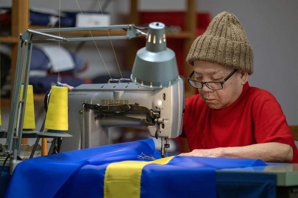 Using a vintage 1950s Singer sewing machine, seamstress Phuong-Thu Nguyen, 78, guides fabric beneath the double needles as she makes a flag of Curaçao at All Nations Flag Co. on Thursday, Jan. 8, 2026, in Kansas City. Curaçao is one of seven nations set to compete in the FIFA World Cup matches hosted in Kansas City this summer. All Nations Flag Co., is gearing up for the thousands of fans that will descend on Kansas City for the matches.